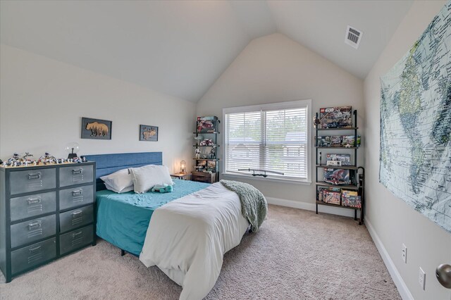 bedroom with vaulted ceiling, carpet flooring, and baseboards