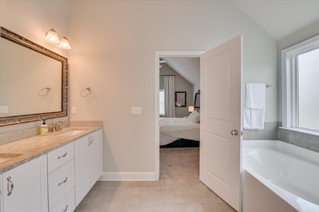 full bath with lofted ceiling, plenty of natural light, ensuite bathroom, and a garden tub