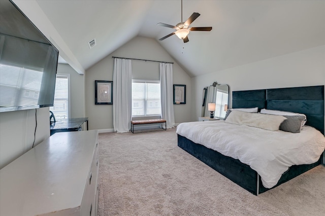 bedroom featuring light carpet, multiple windows, vaulted ceiling, and ceiling fan