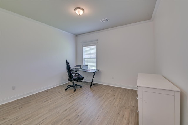 office area with ornamental molding, light wood-style floors, and baseboards