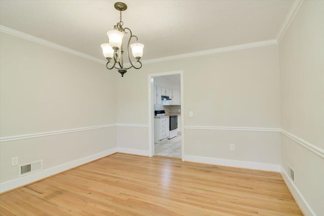 427 Ashland Dr, Augusta, GA 30909 - spare room with a chandelier, light wood-type flooring, and crown molding