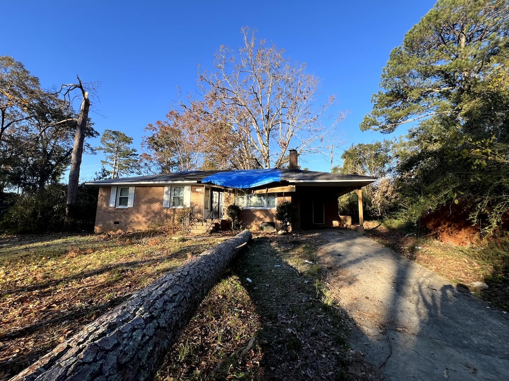 ranch-style house featuring a carport