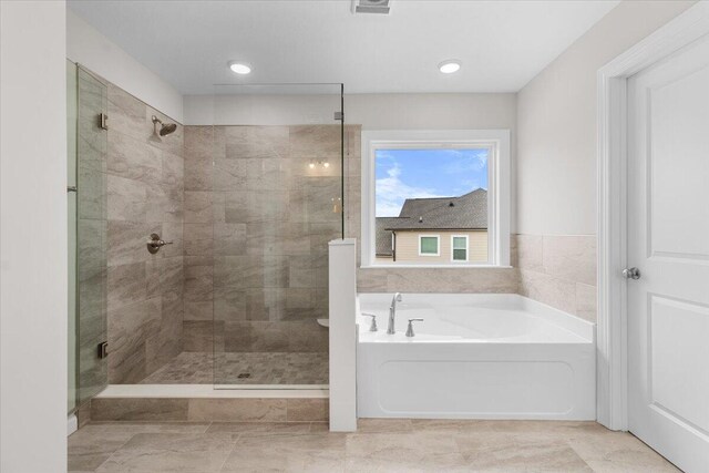 bathroom with a bath and a shower stall