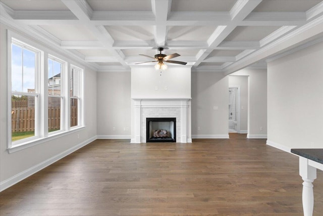 unfurnished living room with a fireplace, baseboards, a ceiling fan, and dark wood-style flooring