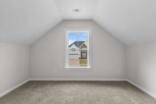 bonus room featuring vaulted ceiling, visible vents, carpet flooring, and baseboards