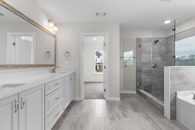 full bathroom featuring double vanity, visible vents, a stall shower, a sink, and a bath