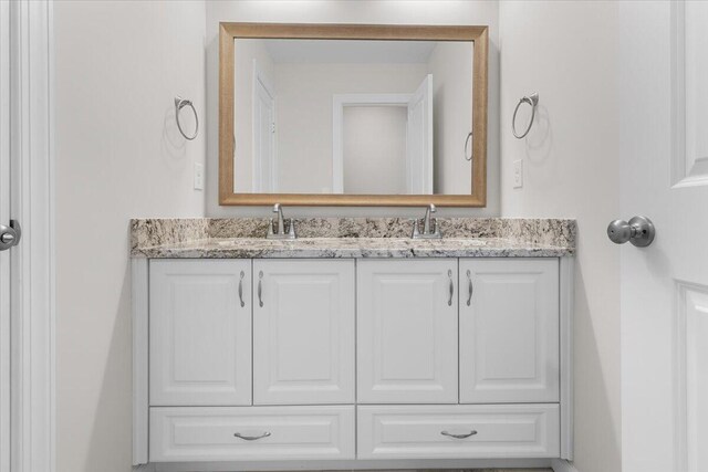 bathroom featuring double vanity and a sink