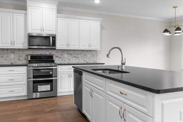 kitchen featuring a sink, white cabinets, dark countertops, and appliances with stainless steel finishes