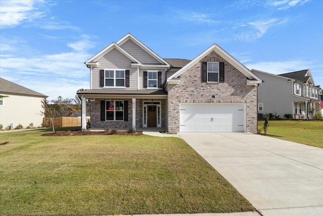 view of front of property featuring covered porch, a garage, and a front lawn