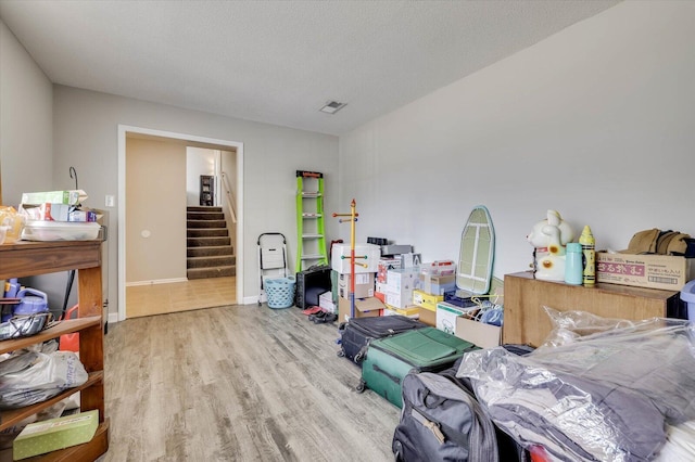 miscellaneous room with wood-type flooring and a textured ceiling