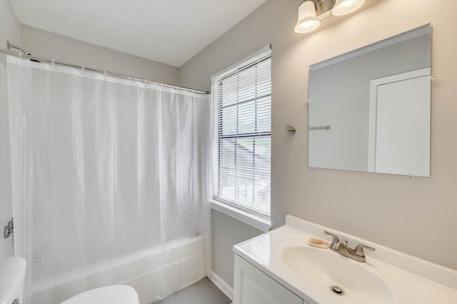 full bathroom featuring shower / bath combo with shower curtain, vanity, and toilet