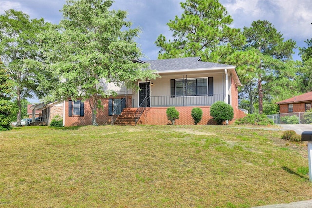 view of front of property with covered porch and a front lawn