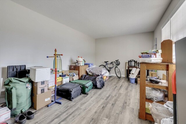 miscellaneous room featuring light hardwood / wood-style floors and a textured ceiling