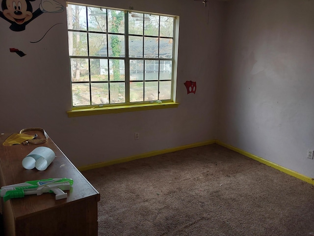 empty room with baseboards and carpet floors