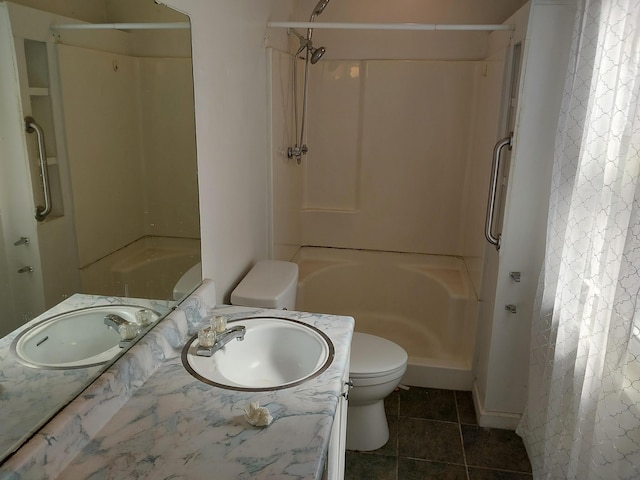 bathroom featuring tile patterned floors, vanity, toilet, and a shower