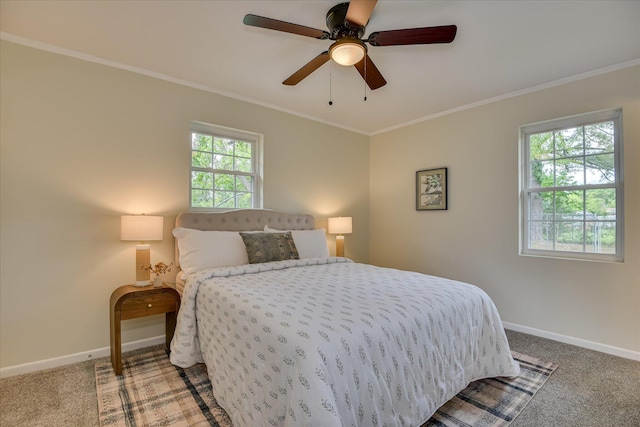carpeted bedroom featuring crown molding, baseboards, and a ceiling fan