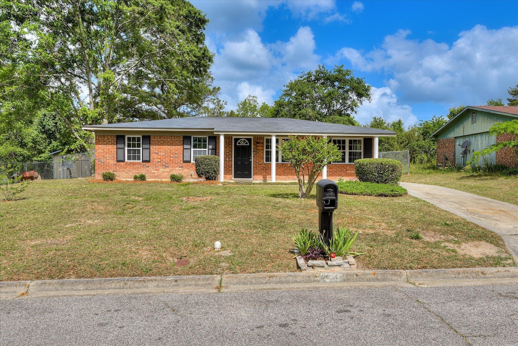 3605 Alene Cir, Augusta, GA 30906 - ranch-style home with concrete driveway, brick siding, fence, and a front lawn