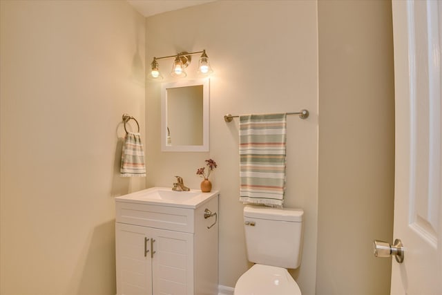 bathroom featuring toilet and vanity