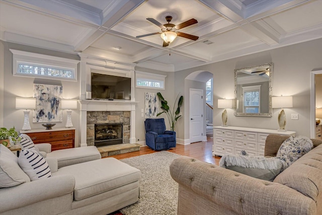 living room with beam ceiling, coffered ceiling, and ornamental molding