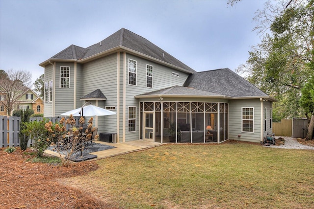 back of house with a yard and a patio