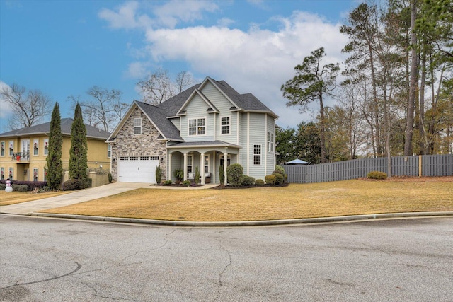 front of property featuring covered porch and a garage