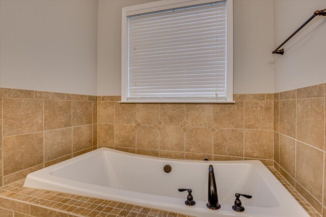 bathroom featuring tiled bath