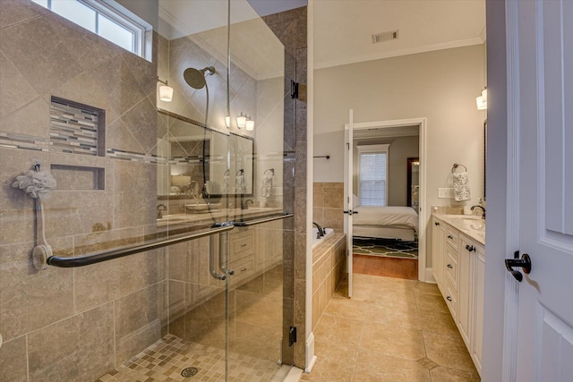 bathroom with tile patterned floors, vanity, a shower with shower door, and ornamental molding