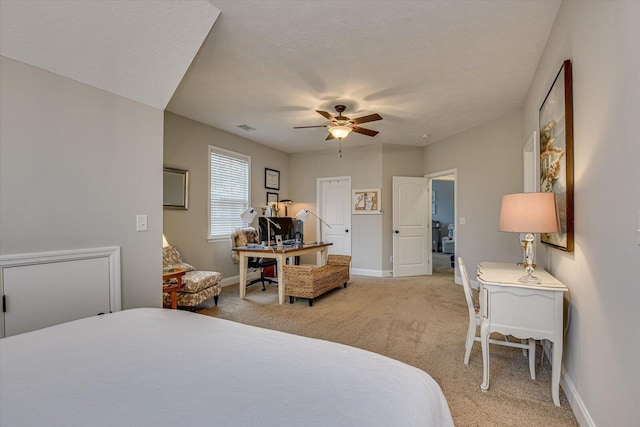 bedroom featuring ceiling fan, carpet floors, and a textured ceiling