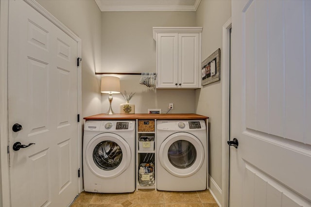 washroom with cabinets, crown molding, light tile patterned floors, and washer and dryer