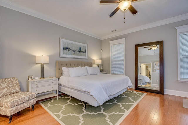 bedroom featuring light hardwood / wood-style flooring, ceiling fan, and crown molding