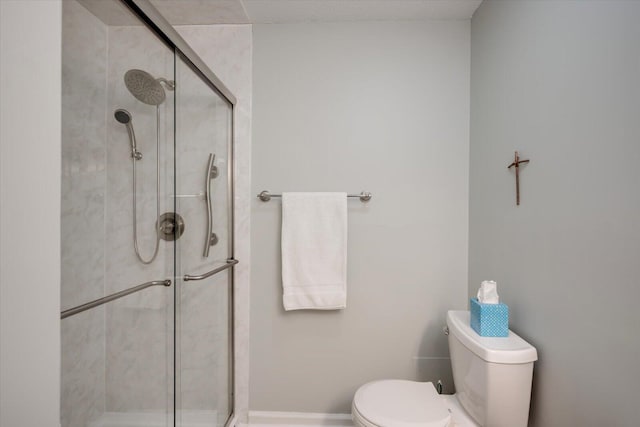 bathroom featuring toilet and walk in shower