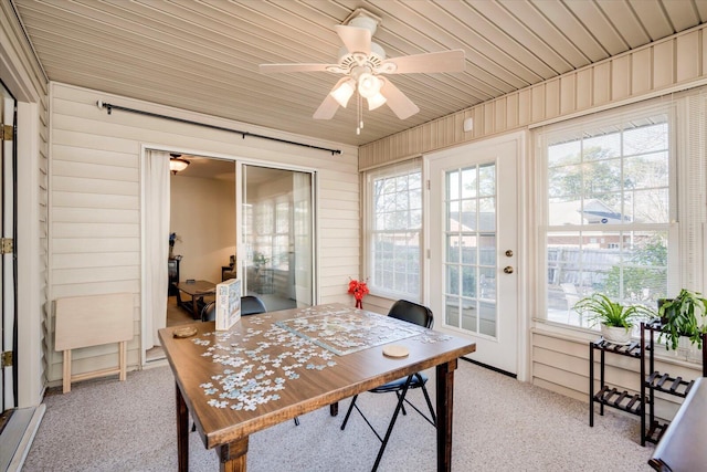 sunroom / solarium with ceiling fan and wood ceiling