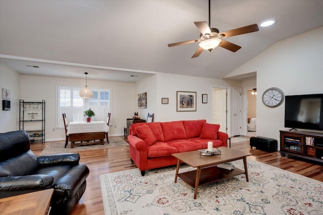 living room with ceiling fan, lofted ceiling, and light wood-type flooring