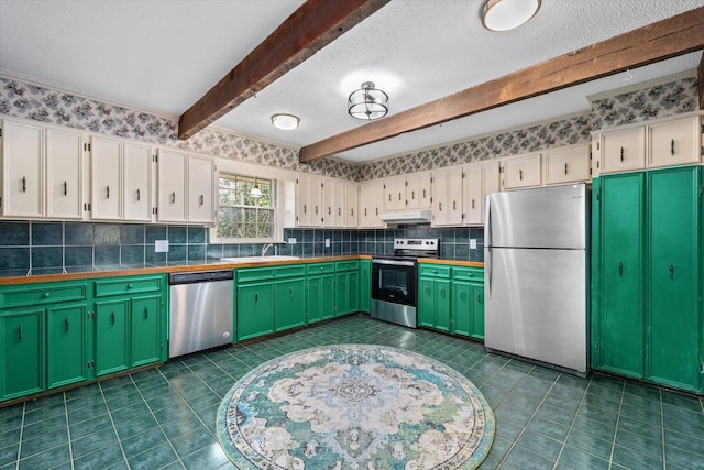 2216 Silverdale Rd, Augusta, GA 30906 - kitchen with stainless steel appliances, a sink, white cabinetry, under cabinet range hood, and beam ceiling