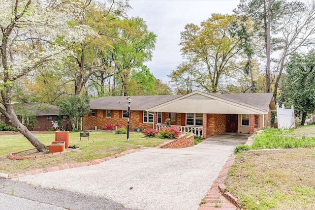 2216 Silverdale Rd, Augusta, GA 30906 - ranch-style home featuring asphalt driveway, brick siding, a front yard, a porch, and an attached carport