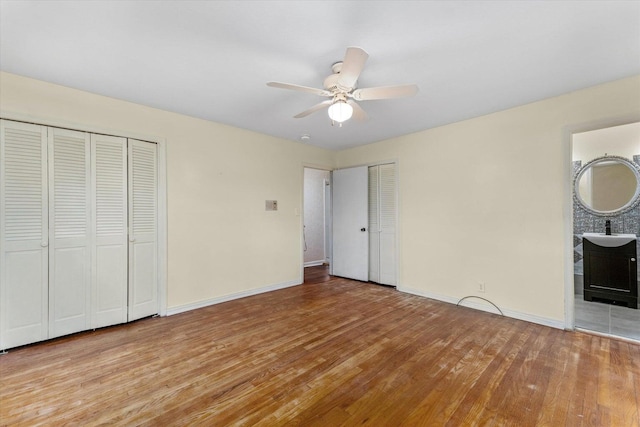 2216 Silverdale Rd, Augusta, GA 30906 - unfurnished bedroom featuring multiple closets, light wood-style floors, baseboards, and ensuite bath
