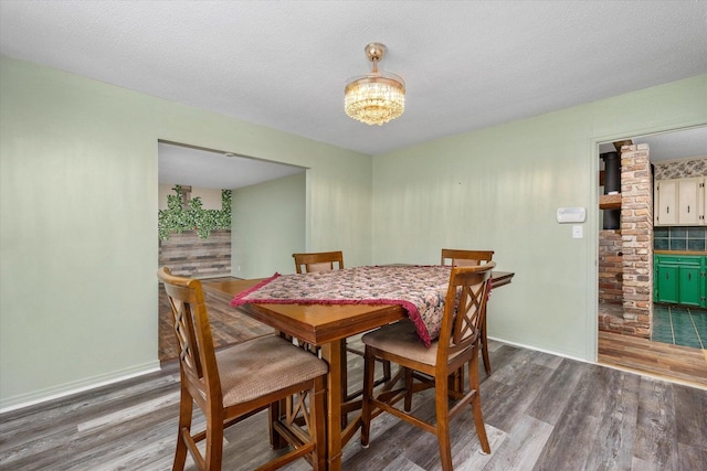 2216 Silverdale Rd, Augusta, GA 30906 - dining room featuring wood finished floors, a chandelier, and baseboards