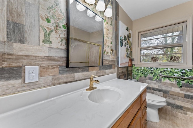 2216 Silverdale Rd, Augusta, GA 30906 - bathroom with vanity, toilet, tile walls, and a shower with door