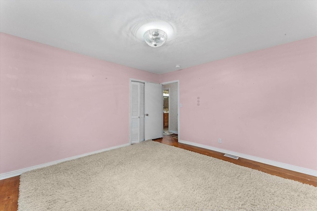 2216 Silverdale Rd, Augusta, GA 30906 - unfurnished bedroom with baseboards, a closet, and wood finished floors