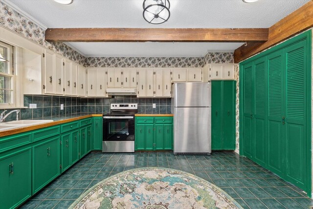 2216 Silverdale Rd, Augusta, GA 30906 - kitchen featuring appliances with stainless steel finishes, under cabinet range hood, beamed ceiling, white cabinets, and tile counters