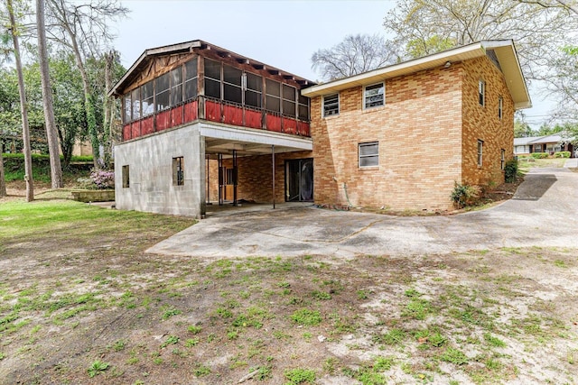2216 Silverdale Rd, Augusta, GA 30906 - back of property with a sunroom, brick siding, and a patio area