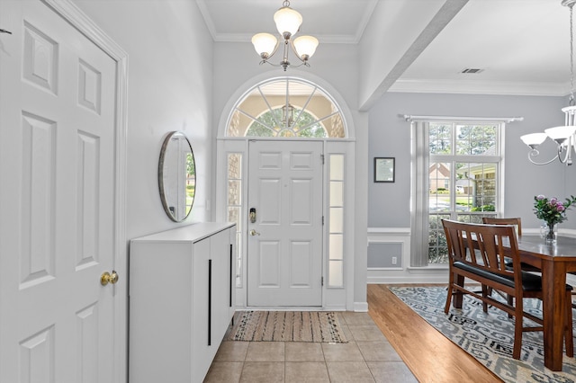 1382 Shadow Oak Dr, Evans, GA 30809 - foyer entrance featuring a chandelier, ornamental molding, light tile patterned flooring, and wainscoting