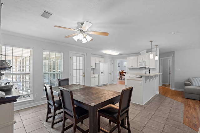 1382 Shadow Oak Dr, Evans, GA 30809 - dining area featuring ceiling fan, light tile patterned flooring, crown molding, and baseboards