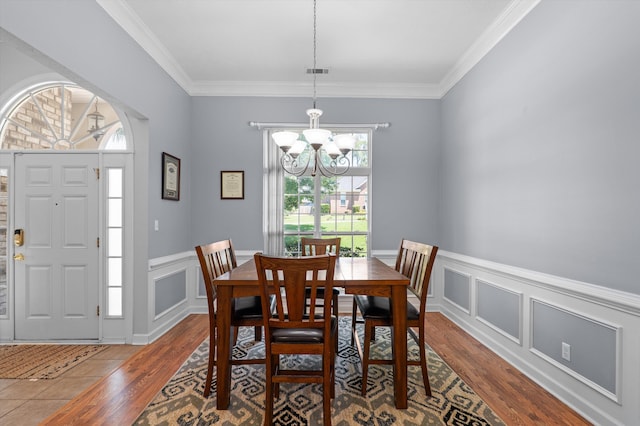 1382 Shadow Oak Dr, Evans, GA 30809 - dining room with a chandelier, wood finished floors, crown molding, wainscoting, and a decorative wall