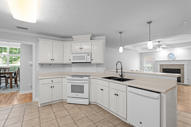 1382 Shadow Oak Dr, Evans, GA 30809 - kitchen with white appliances, a sink, a peninsula, a ceiling fan, and white cabinetry