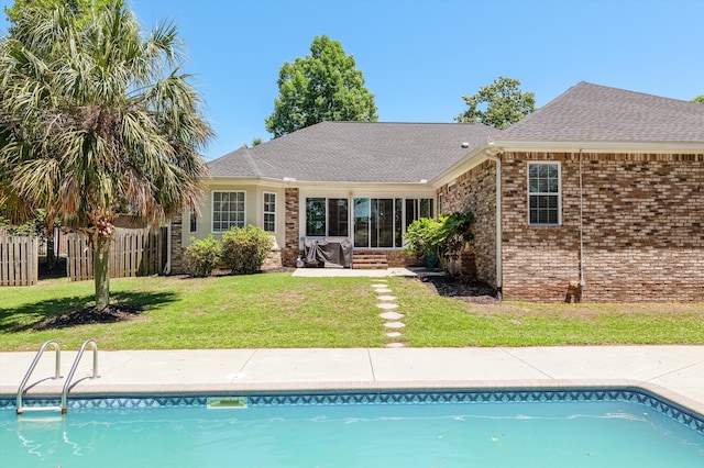 1382 Shadow Oak Dr, Evans, GA 30809 - rear view of house with an outdoor pool, brick siding, roof with shingles, and a patio area