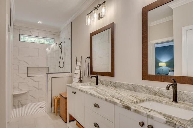 bathroom featuring vanity, ornamental molding, and tiled shower