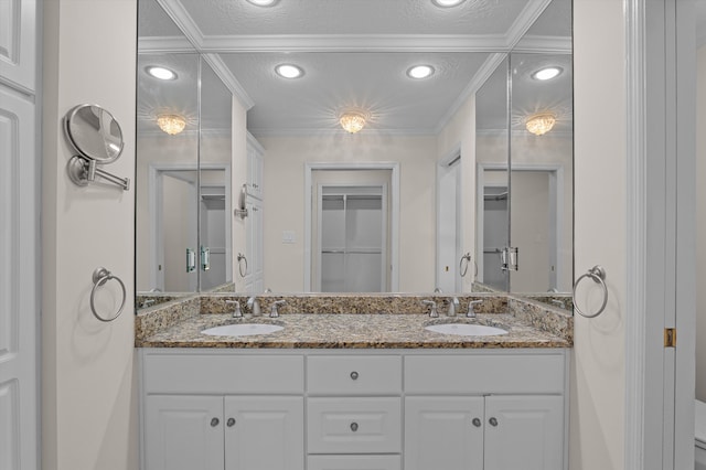3076 Westwood Rd, Augusta, GA 30909 - bathroom featuring double vanity, crown molding, a closet, recessed lighting, and a textured ceiling
