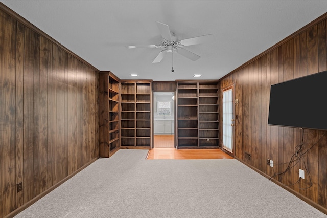 3076 Westwood Rd, Augusta, GA 30909 - carpeted empty room with wooden walls, a ceiling fan, crown molding, and built in features