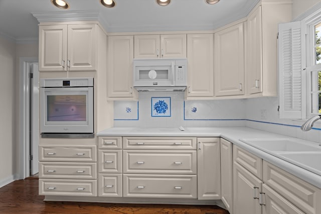 3076 Westwood Rd, Augusta, GA 30909 - kitchen featuring white appliances, white cabinets, decorative backsplash, ornamental molding, and light countertops